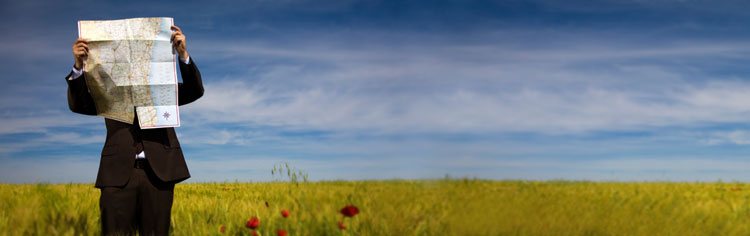 Navigating with map in an open field - All About The Journey Banner